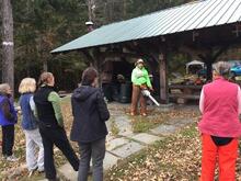 tish carr demonstrating the proper technique for starting a chainsaw. carr and Amanda Mahaffey led a Women’s Chainsaw Safety Training at Yale-Myers in October 2019, put on by QCI and the Forest Stewards Guild.