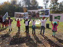 Children of Cherry Ann Park hold up signs of projects underway, including the splash pad.