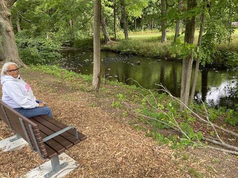 Marlene Miller Pratt sitting in her favorite spot at the New Haven Botanical Garden of Healing.